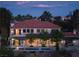 Expansive two-story home featuring a red tile roof, backyard pool, and covered outdoor dining at 1413 Iron Hills Ln, Las Vegas, NV 89134