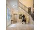 Elegant foyer with tile flooring, staircase with iron railing, and grand entry doors at 1413 Iron Hills Ln, Las Vegas, NV 89134