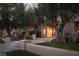 Inviting front yard with manicured lawn, mature trees and walkway leading to front entrance at 1413 Iron Hills Ln, Las Vegas, NV 89134