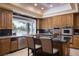 Well-equipped kitchen boasting stainless steel appliances, a center island, and a window offering scenic views at 1413 Iron Hills Ln, Las Vegas, NV 89134