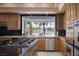 Gourmet kitchen featuring stainless steel appliances, granite countertops, and a breakfast bar at 1413 Iron Hills Ln, Las Vegas, NV 89134
