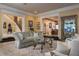 Elegant living room featuring plush seating, a decorative rug, and views of the staircase and adjoining rooms at 1413 Iron Hills Ln, Las Vegas, NV 89134
