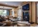 Inviting living room with a cozy fireplace and plush leather furniture, perfect for relaxing and entertaining at 1413 Iron Hills Ln, Las Vegas, NV 89134