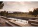 Luxury infinity pool overlooks a golf course with mountain views at 1413 Iron Hills Ln, Las Vegas, NV 89134