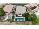 A beautiful home featuring a private rectangular swimming pool and lush backyard at 1701 Tesara Vista Pl, Las Vegas, NV 89128