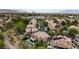 Aerial view of a neighborhood showcasing a home with a pool and balcony in a desirable community at 1701 Tesara Vista Pl, Las Vegas, NV 89128