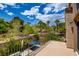 Private balcony overlooking the landscaped backyard with mature trees and an in-ground pool at 1701 Tesara Vista Pl, Las Vegas, NV 89128