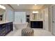 Bathroom with modern vanity, soaking tub, glass block window, and tiled floors at 1701 Tesara Vista Pl, Las Vegas, NV 89128