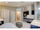 This elegant primary bathroom features dual vanities, freestanding tub, fireplace and access to the primary bedroom at 1701 Tesara Vista Pl, Las Vegas, NV 89128