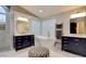 The primary bathroom includes separate vanities, marble floors, a free-standing soaking tub, and glass block window at 1701 Tesara Vista Pl, Las Vegas, NV 89128
