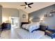 Bedroom with a ceiling fan, carpeted floor, large windows and grey accent wall at 1701 Tesara Vista Pl, Las Vegas, NV 89128