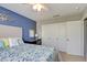 Bedroom with blue accent wall, white closet doors, carpet, and ceiling fan at 1701 Tesara Vista Pl, Las Vegas, NV 89128