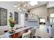 Bright dining room featuring a modern chandelier, hardwood floors, and a staircase to the upper level at 1701 Tesara Vista Pl, Las Vegas, NV 89128