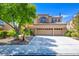Beautiful two-story home featuring a spacious three-car garage and well-maintained landscaping at 1701 Tesara Vista Pl, Las Vegas, NV 89128