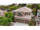 Aerial view of a well-maintained home with a tile roof, three-car garage, and backyard pool at 1701 Tesara Vista Pl, Las Vegas, NV 89128