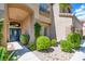 Charming home featuring a blue front door and well-manicured landscaping at 1701 Tesara Vista Pl, Las Vegas, NV 89128