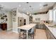Bright kitchen with stainless steel appliances, island seating, and white and gray cabinetry at 1701 Tesara Vista Pl, Las Vegas, NV 89128