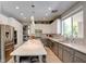 Spacious kitchen features a large island, stainless steel appliances, and a breakfast bar at 1701 Tesara Vista Pl, Las Vegas, NV 89128