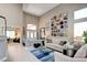 Bright living room with high ceilings, stylish decor, and abundant natural light at 1701 Tesara Vista Pl, Las Vegas, NV 89128
