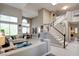 Spacious living room with soaring ceilings, neutral tones, and an open layout at 1701 Tesara Vista Pl, Las Vegas, NV 89128