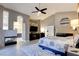 Spacious primary bedroom with fireplace, ceiling fan, and access to the ensuite bathroom at 1701 Tesara Vista Pl, Las Vegas, NV 89128