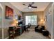 Comfortable home office with a ceiling fan, a large window, and a dark leather armchair at 1701 Tesara Vista Pl, Las Vegas, NV 89128