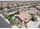 Aerial view showcasing a house with a pool, solar panels, and meticulously kept landscaping in a vibrant neighborhood at 176 Jay Porter Ave, Henderson, NV 89002
