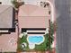 Aerial view of a home's backyard featuring a pool, spa, and neatly manicured landscaping at 176 Jay Porter Ave, Henderson, NV 89002