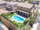 Aerial view of a backyard with a pool, spa, covered patio, and lush landscaping at 176 Jay Porter Ave, Henderson, NV 89002