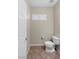 Powder bathroom features a toilet, window, and neutral walls at 176 Jay Porter Ave, Henderson, NV 89002