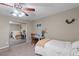 Relaxing bedroom featuring a bed, desk, ceiling fan, and mirrored closet at 176 Jay Porter Ave, Henderson, NV 89002