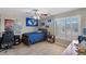 Bedroom featuring a bed, ceiling fan, desk, and window with white shutters at 176 Jay Porter Ave, Henderson, NV 89002