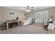 Relaxing bedroom featuring a bed, desk, ceiling fan, and window at 176 Jay Porter Ave, Henderson, NV 89002