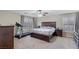 A spacious bedroom with a large bed, treadmill, and ample natural light at 176 Jay Porter Ave, Henderson, NV 89002