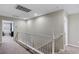 A carpeted hallway includes a white banister and access to other rooms at 176 Jay Porter Ave, Henderson, NV 89002