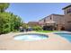 Inviting hot tub area complete with artificial turf, mature landscaping, and seating at 176 Jay Porter Ave, Henderson, NV 89002
