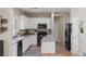 Bright kitchen with stainless steel appliances, white cabinetry, and quartz countertops at 176 Jay Porter Ave, Henderson, NV 89002