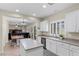 Open kitchen with stainless steel appliances, a breakfast bar, and a view into the living room at 176 Jay Porter Ave, Henderson, NV 89002