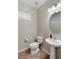 Neutral powder room with a pedestal sink, toilet, and modern fixtures at 176 Jay Porter Ave, Henderson, NV 89002