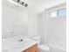 Clean bathroom with tub and shower combination, neutral tile, and a wooden vanity at 185 Renville Ct, Henderson, NV 89074