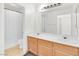 Bright bathroom features a double sink vanity with wood cabinets and tile flooring at 185 Renville Ct, Henderson, NV 89074