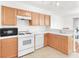 Cozy kitchen featuring wooden cabinetry, white countertops, and modern appliances at 185 Renville Ct, Henderson, NV 89074