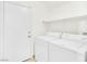 Functional laundry room with a washer, dryer, and a storage shelf at 185 Renville Ct, Henderson, NV 89074
