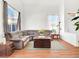Bright living room featuring wood floors, large windows, and comfortable seating area at 185 Renville Ct, Henderson, NV 89074