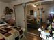 Bedroom features a mirrored closet door and bed with a colorful quilted pattern at 1930 N Murphy St, Pahrump, NV 89060