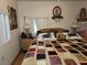 Cozy bedroom with a colorful quilted bed, bedside table, and decorative accents at 1930 N Murphy St, Pahrump, NV 89060