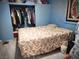 Cozy bedroom with blue walls, a closet and a floral bedspread at 1930 N Murphy St, Pahrump, NV 89060