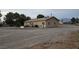 Exterior side view of a home with an expansive gravel yard and mountain views in the distance at 1930 N Murphy St, Pahrump, NV 89060