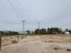 Empty lot with utility poles and trees nearby at 1930 N Murphy St, Pahrump, NV 89060