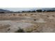 Large dry lot with surrounding neighborhood in the distance at 1930 N Murphy St, Pahrump, NV 89060